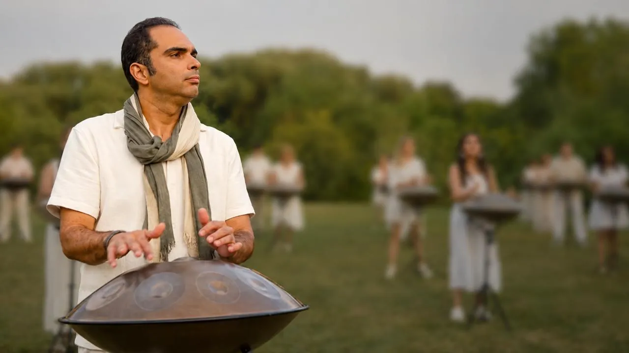 Maziar playing the hang drum on stage